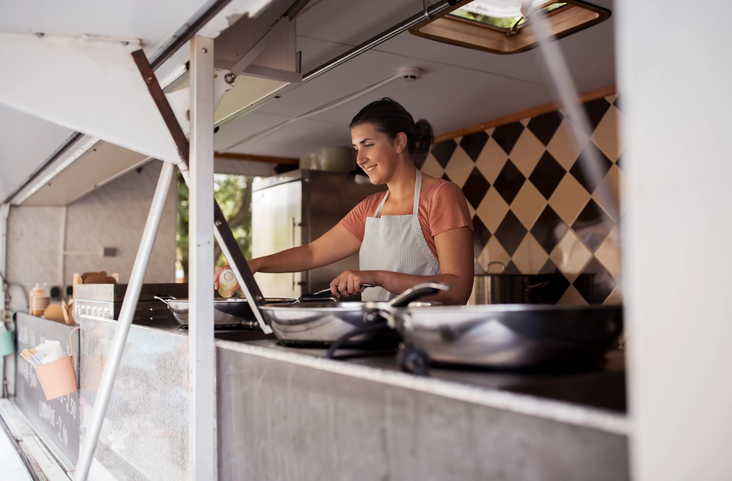 A woman working at a food truck.